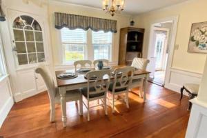 a dining room with a table and chairs at Menauhant Beach Paradise in Falmouth