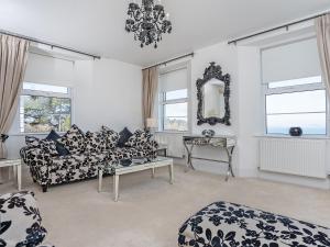 a living room with two couches and a mirror at Babbacombe Bay, Torquay in Torquay