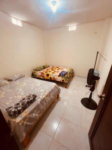 a room with two beds and a camera in it at Seguridad para la familia in Tena