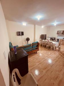 a living room with a couch and a table and chairs at Seguridad para la familia in Tena