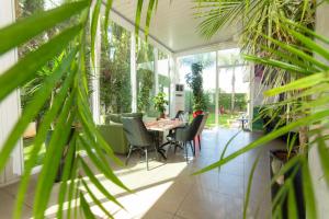 a screened in porch with a table and chairs at Ibis Rabat Agdal in Rabat