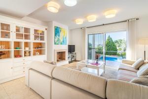 a living room with a couch and a fireplace at Jouvacations Villa Sun Pani in Empuriabrava
