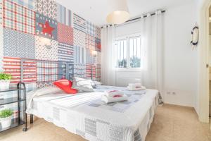 a bedroom with a bed with two pillows on it at Jouvacations Villa Sun Pani in Empuriabrava +40 photos