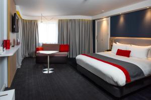 a hotel room with a bed and a desk at Holiday Inn Express London-Hammersmith by IHG in London