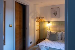 a bedroom with a bed and a door to a room at The Perk Inn Garden Lodge in Broadstone