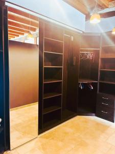 a walk in closet with brown walls and shelves at le petit chai in Levroux