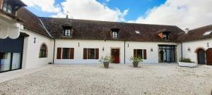 a large white building with windows and a roof at le petit chai in Levroux