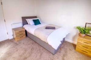 a bedroom with a large bed and a wooden dresser at NEW Contractor 5-Bed 3-Bath Central Redcar in Redcar