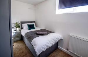 a small bedroom with a bed and a window at NEW Contractor 5-Bed 3-Bath Central Redcar in Redcar
