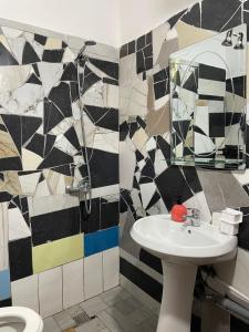 a bathroom with a sink and a mirror at Markev Apartments in Vlorë