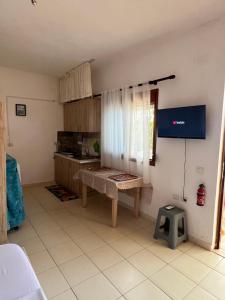 a kitchen with a table and a tv in a room at Markev Apartments in Vlorë +86 photos
