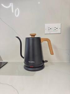 a black tea kettle sitting on top of a counter at The Nest At Paradisiac in Ocho Rios