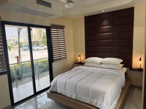 a bedroom with a large bed with a large window at The Nest At Paradisiac in Ocho Rios