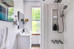 a bathroom with a shower and a sink at Hot Tub Comfort in Walkable Lawrenceville in Lawrenceville +22 photos