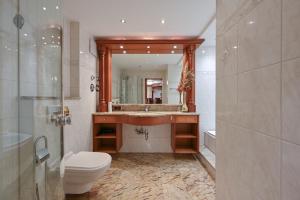 a bathroom with a sink and a toilet and a mirror at Hotel San Marco in Füssen +90 photos
