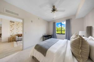 a white bedroom with a bed and a window at Aqua Luxe in DTWN 3 Min From Las Olas in Fort Lauderdale +50 photos