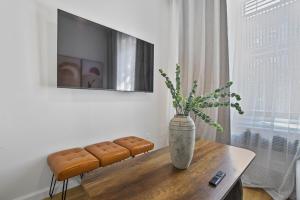 a vase sitting on a table in a living room at 2 BD Tranquil Unit close to Central Park in New York