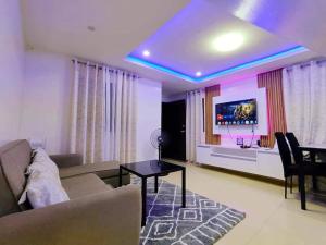 a living room with a couch and a table at AVA Cabanatuan Transient House in Bantug +3 photos