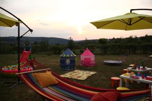 a group of tents with a hammock and an umbrella at ART HOUSE Kosmaj 1 in Sopot