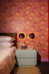 a bedroom with a bed and a side table at Hotel Hilo - Room 102 in Louisville