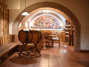 a room with a wine barrel on a stand in a store at Mercure Sighisoara Binderbubi Hotel & Spa in Sighişoara