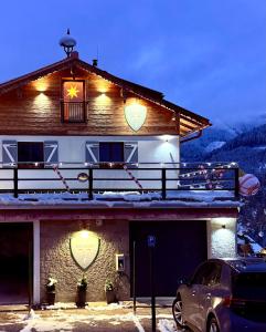 a building with a star on the side of it at ALM SEASONS Premium Chalet & Studios in Saalbach Hinterglemm