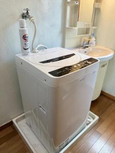 a white sink in a bathroom with a sink at Otter Stay Lite - Habashita in Nagoya