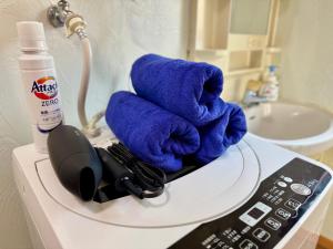 a blue towel sitting on top of a microwave at Otter Stay Lite - Habashita in Nagoya +26 photos