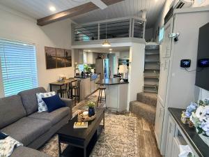a living room with a couch and a kitchen at The Refuge at Vanderosa in Conroe
