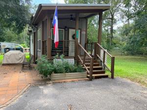 a house with a porch with a flag on it at The Refuge at Vanderosa in Conroe