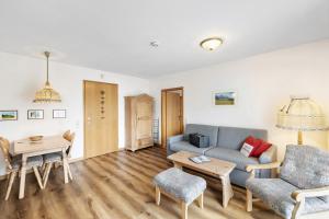 ein Wohnzimmer mit Sofa und Tisch in der Unterkunft Fewo Brünnstein - Nr 44 Pool, Sauna in Oberaudorf