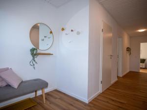 a living room with a mirror and a couch at 217 Schortens in Schortens