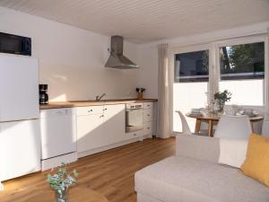 a kitchen and living room with a couch and a table at 217 Schortens in Schortens