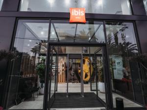 a ups store with a guitar in the front door at Ibis Mohammedia in Mohammedia