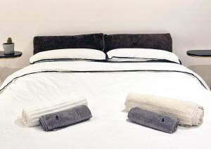 a large white bed with two towels on it at Renovated 1B Studio Apartment w Balcony in Central Brixton in London