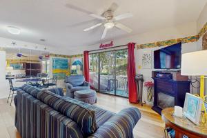 a living room with a couch and a tv at Beachwood Villas 7C in Seagrove Beach