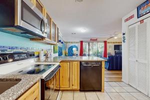 a kitchen with wooden cabinets and a stainless steel appliance at Beachwood Villas 7C in Seagrove Beach
