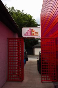 a red entrance to a building with a sign on it at Hotel Hilo - Room 202 in Louisville