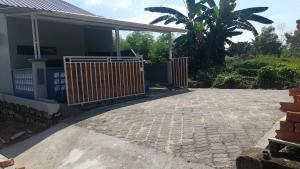 a driveway with a gate in front of a house at JH homestay 