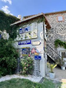 a building with signs on the side of it at Les Hirondelles du Marais in Ennezat +9 photos