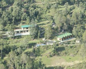 an aerial view of a house on a hill at Paradise Village Resort in Shimla +1 photo