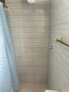 a bathroom with a shower with a glass door at Home in Tulcán