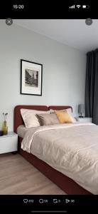 a bedroom with a large bed with white sheets at Confetti in Kremenchuk