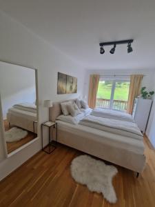 a bedroom with a large bed and a large mirror at Haus Slechta in Jochberg