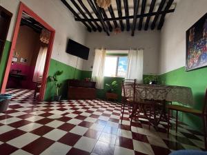 a room with a checkered floor and a table and chairs at Casona del Negro Aguilar in Valladolid