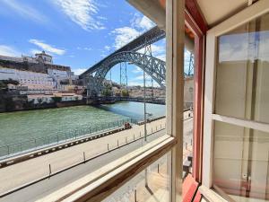 a view of the sydney harbour bridge from a window at Ribeira Cinema Apartments in Porto