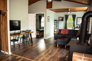 a living room with a couch and a table at Cozy Forest Escape with Porch and AC in Lost City