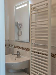 a bathroom with a sink and a mirror at CconfortHotels Sea Dream Palace 1 in Trani