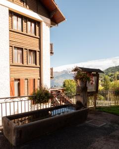 a building with a balcony with flowers on it at Hotel Chalet du Crey in Valmorel