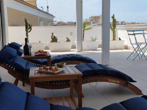 a patio with couches and a table with food on it at CconfortHotels Sea Dream Palace 1 in Trani